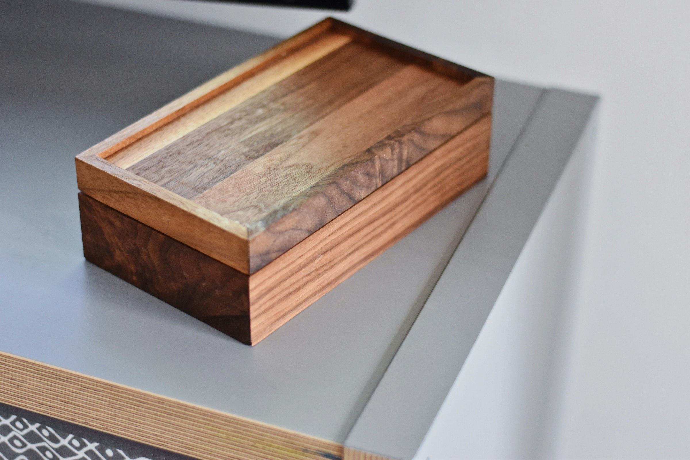 A handcrafted timber box on a pale surface
